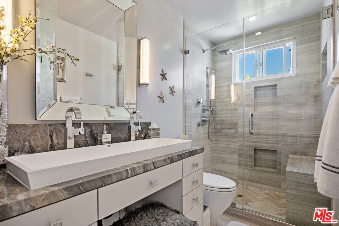 18147 Coastline Drive, Unit 3 Malibu, CA 90265 - Photo 22 of 40 a bathroom with a sink a toilet and shower
