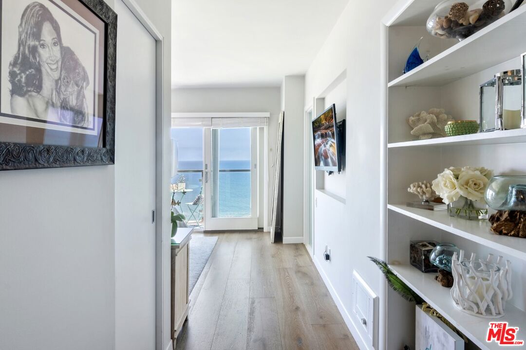 18147 Coastline Drive, Unit 3 Malibu, CA 90265 - Photo 25 of 40 a hallway with a dining table and workspace