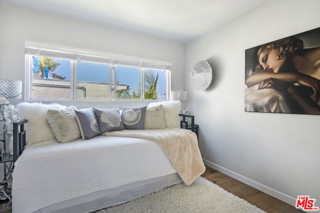 18147 Coastline Drive, Unit 3 Malibu, CA 90265 - Photo 27 of 40 a living room with a bed furniture and a window