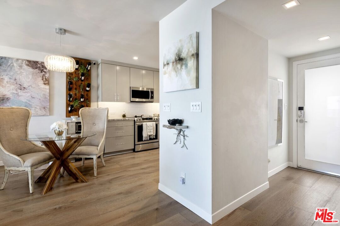 18147 Coastline Drive, Unit 3 Malibu, CA 90265 - Photo 31 of 40 a view of a dining room with furniture and wooden floor