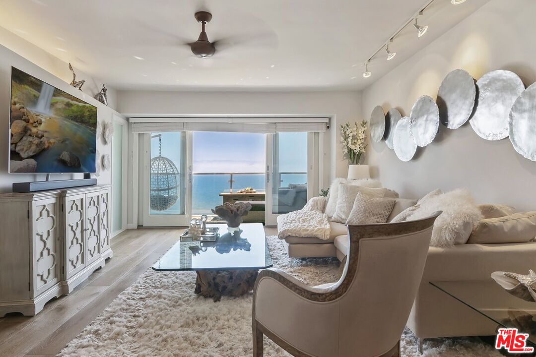 18147 Coastline Drive, Unit 3 Malibu, CA 90265 - Photo 5 of 40 a living room with furniture and a flat screen tv