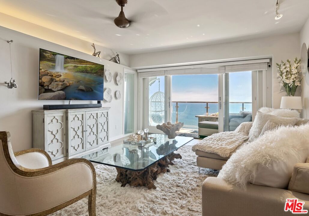 18147 Coastline Drive, Unit 3 Malibu, CA 90265 - Photo 6 of 40 a living room with furniture and a flat screen tv