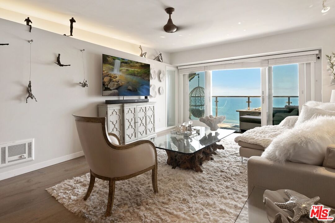 18147 Coastline Drive, Unit 3 Malibu, CA 90265 - Photo 7 of 40 a living room with fireplace furniture and a flat screen tv