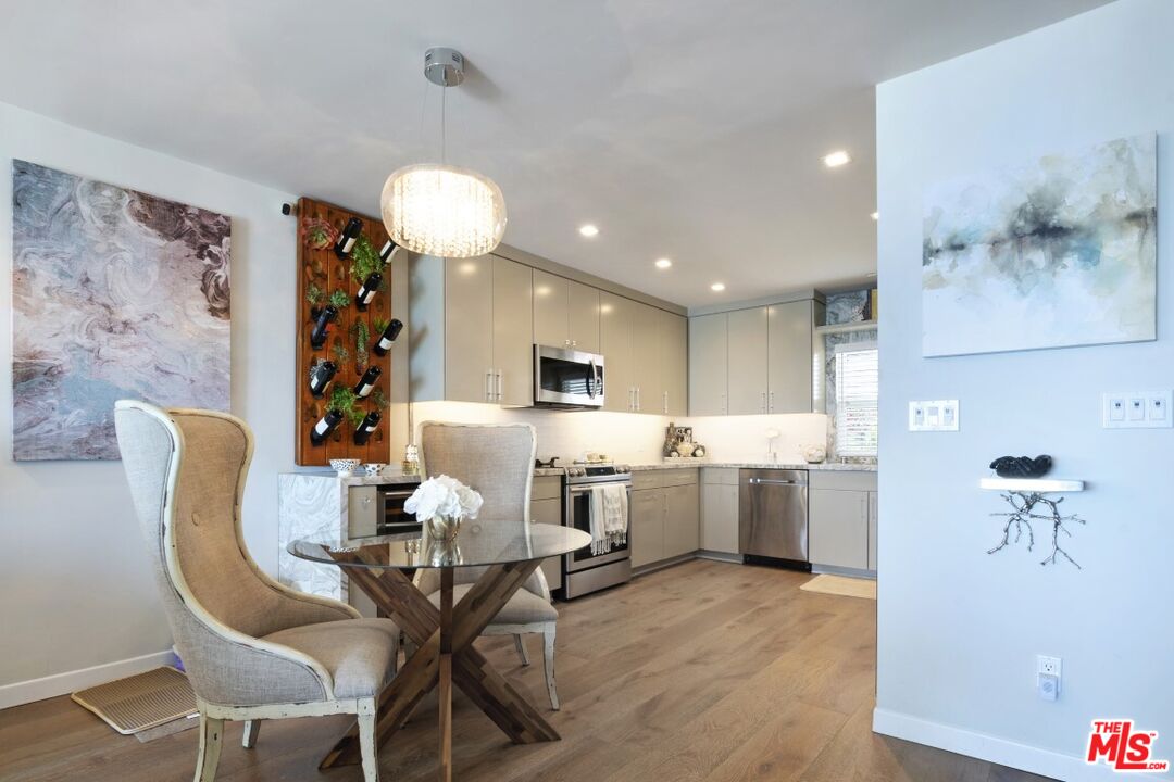 18147 Coastline Drive, Unit 3 Malibu, CA 90265 - Photo 9 of 40 a view of a dining room with furniture and wooden floor