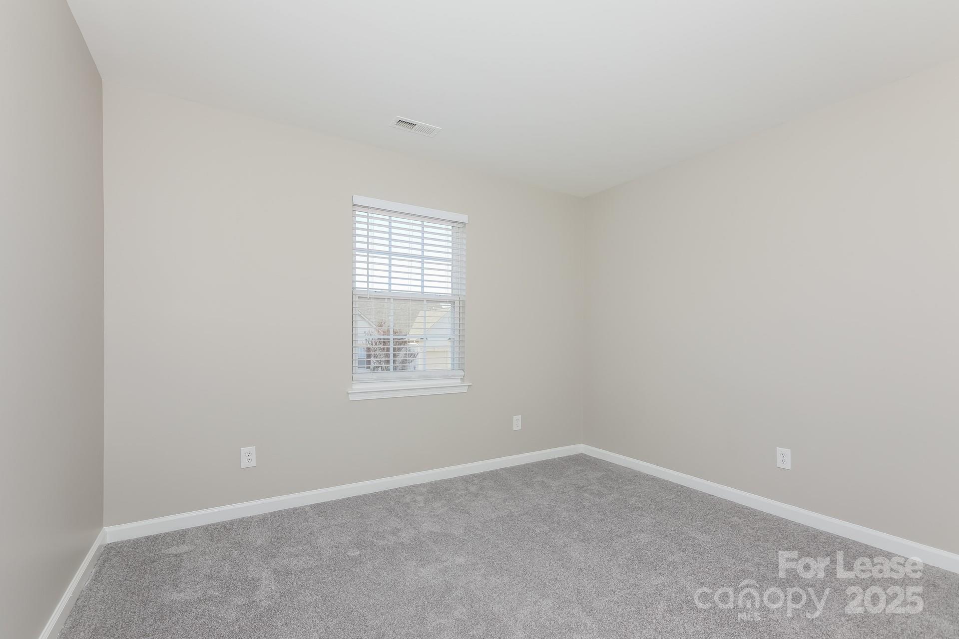 7037 Honey Tree Lane Indian Trail, NC 28079 - Photo 12 of 17 an empty room with a window