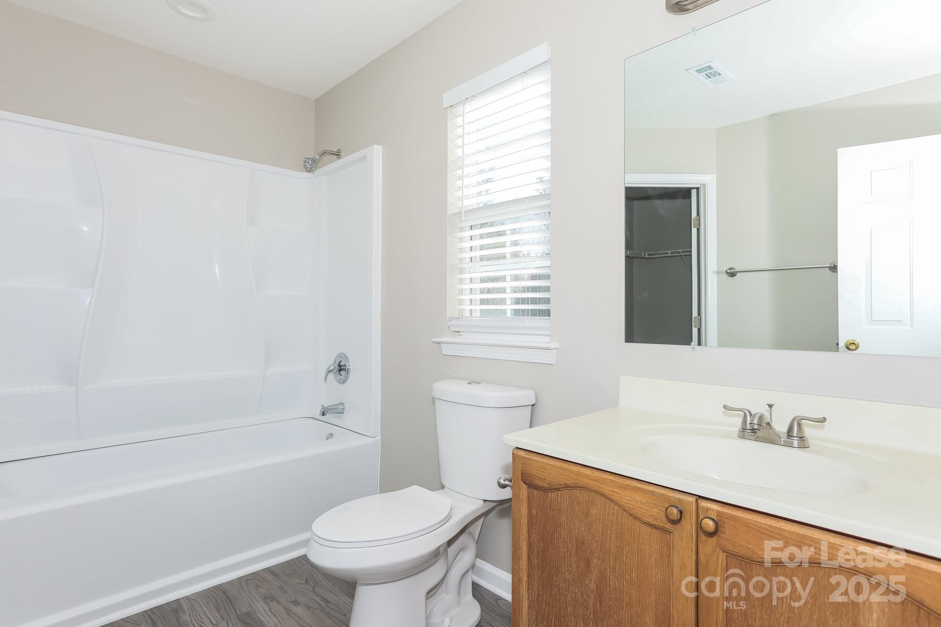 7037 Honey Tree Lane Indian Trail, NC 28079 - Photo 13 of 17 a bathroom with a sink toilet vanity and tub