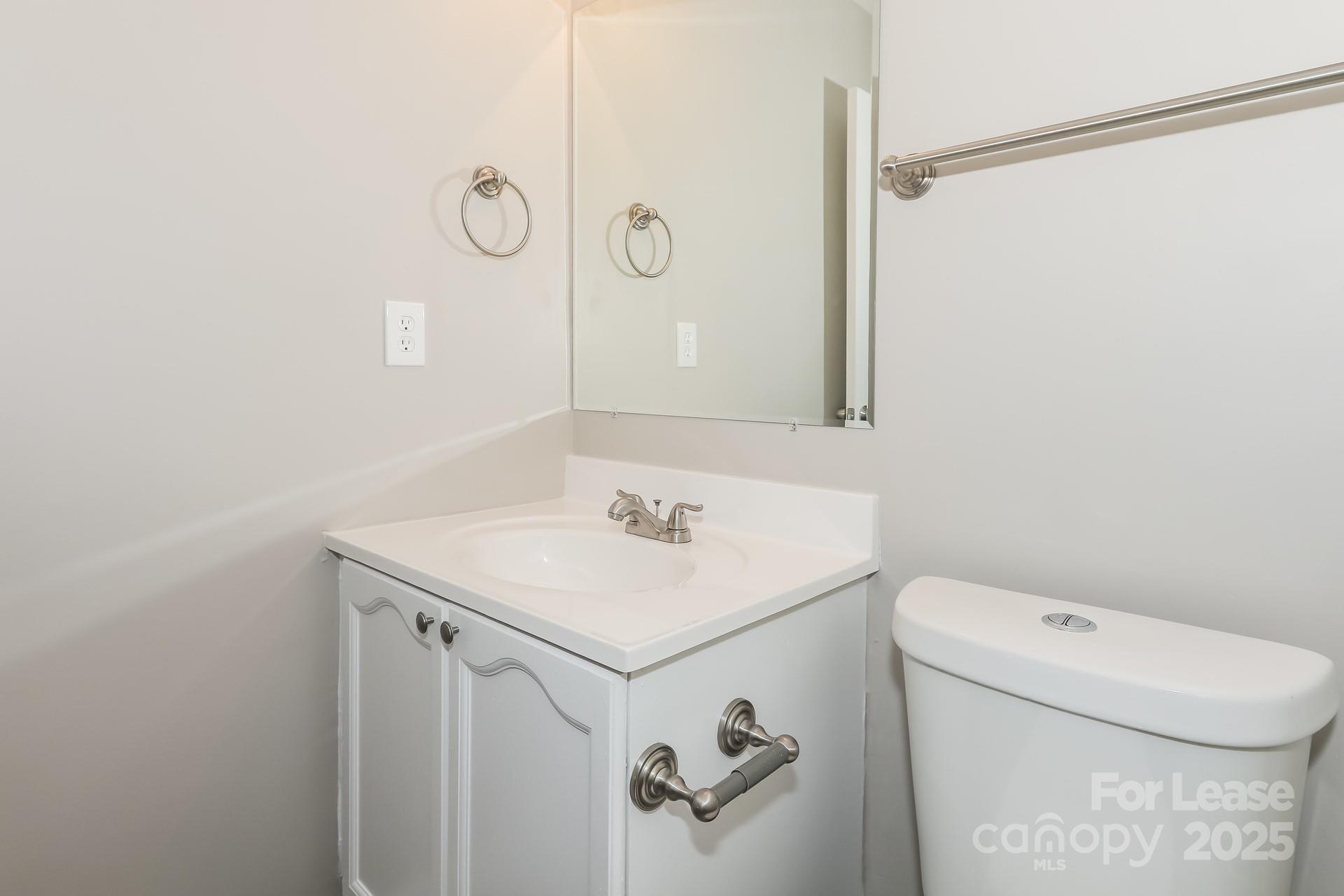7037 Honey Tree Lane Indian Trail, NC 28079 - Photo 14 of 17 a bathroom with a sink a toilet and a mirror