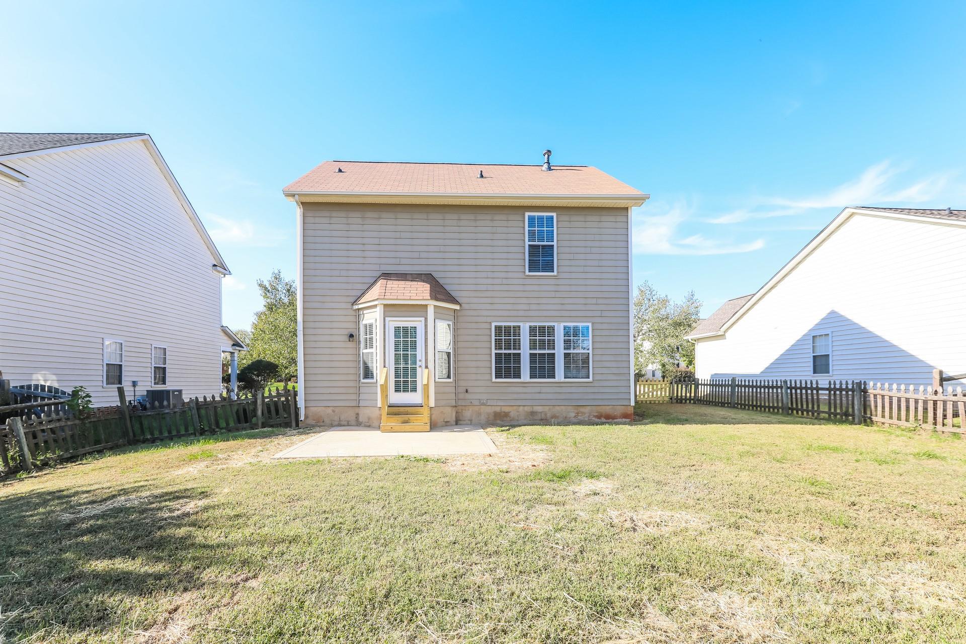 7037 Honey Tree Lane Indian Trail, NC 28079 - Photo 15 of 17 a front view of a house with a yard
