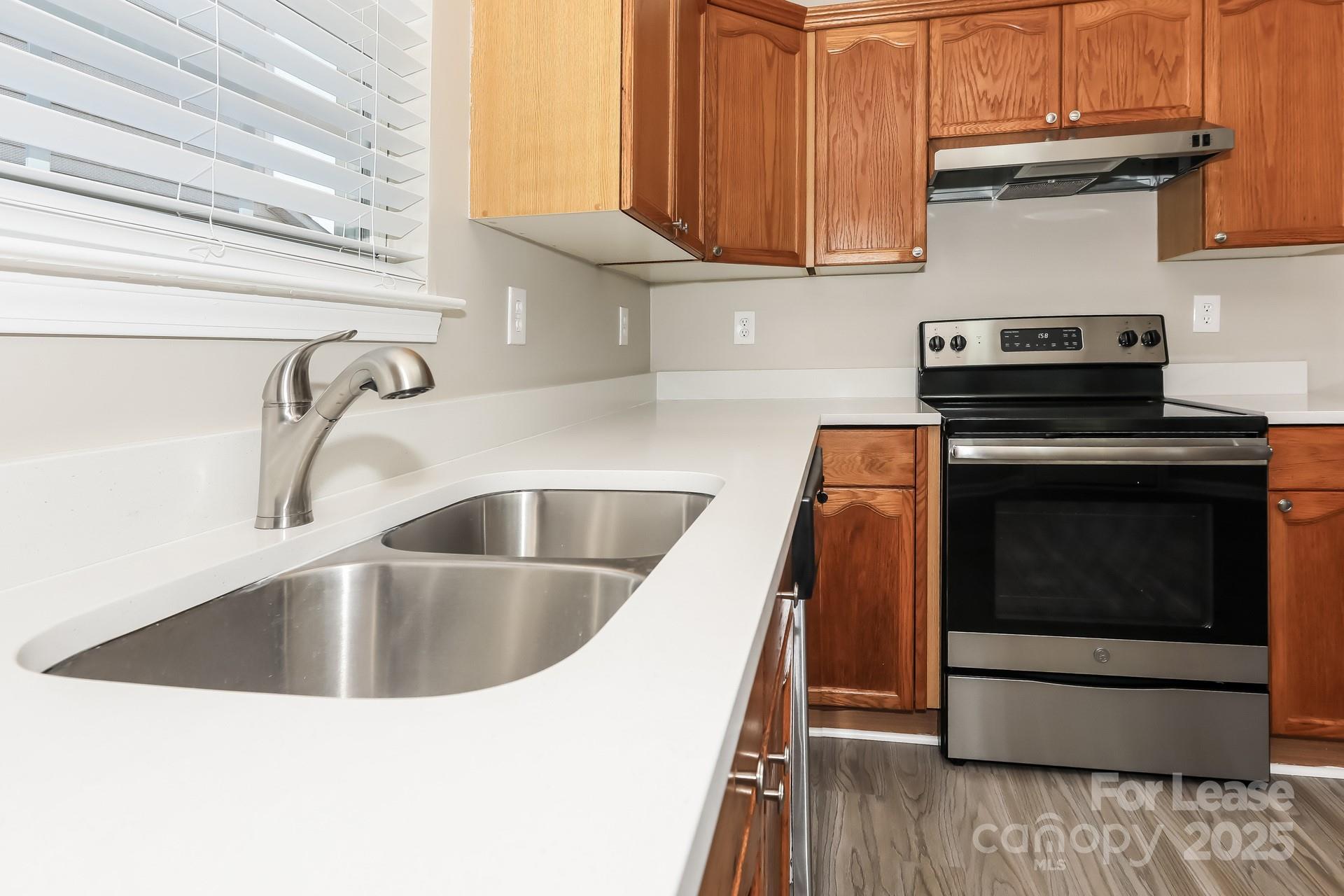 7037 Honey Tree Lane Indian Trail, NC 28079 - Photo 5 of 17 a kitchen with a sink and a stove top oven
