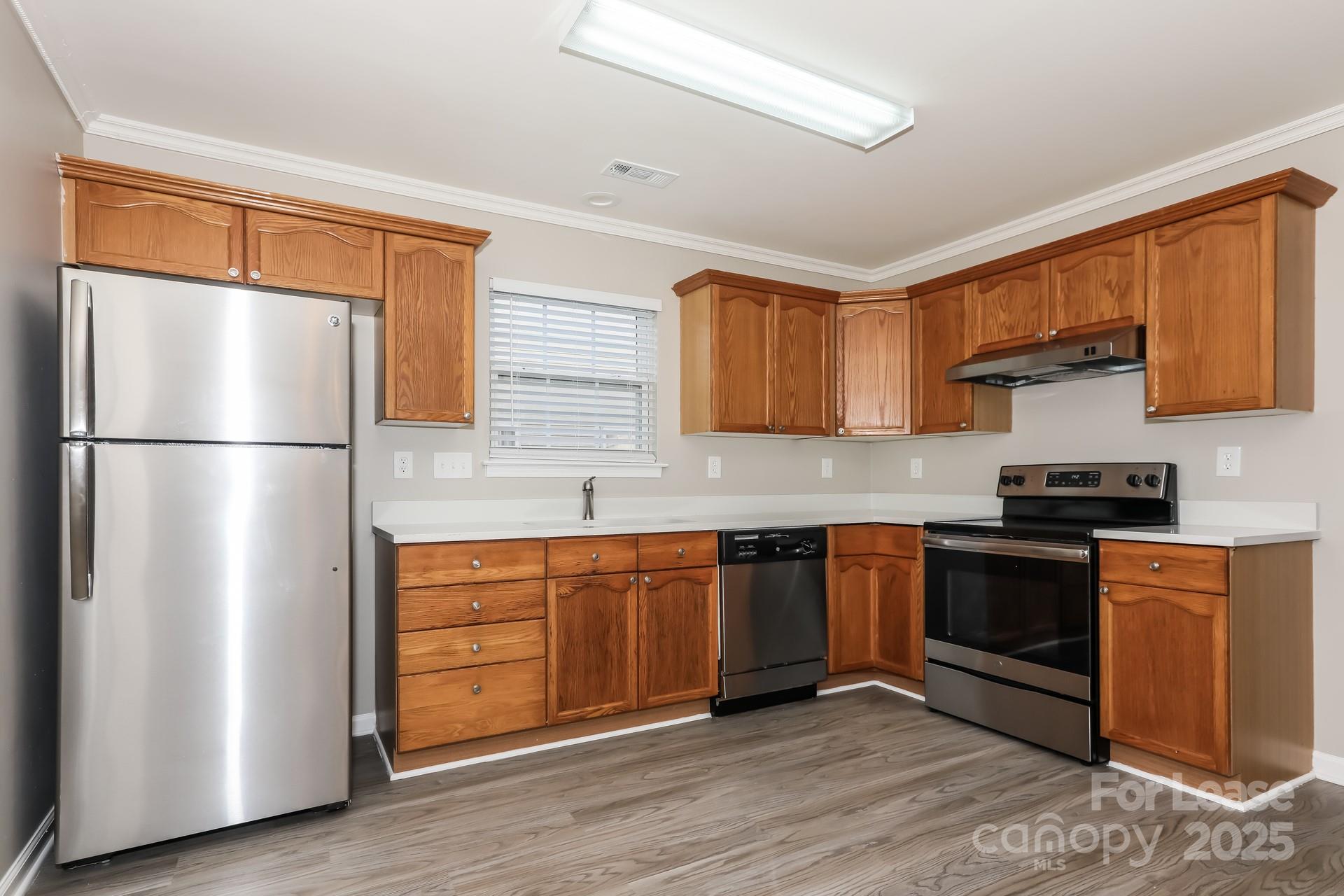 7037 Honey Tree Lane Indian Trail, NC 28079 - Photo 7 of 17 a kitchen with stainless steel appliances granite countertop a refrigerator and a stove top oven