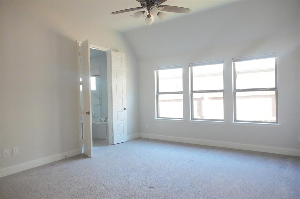 4115 Hudson Street Fate, TX 75087 - Photo 12 of 24 an empty room with a ceiling fan and window