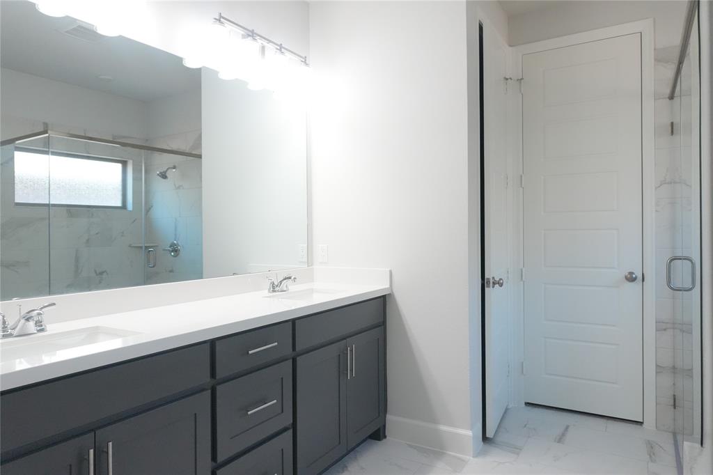 4115 Hudson Street Fate, TX 75087 - Photo 14 of 24 a bathroom with a double vanity sink and mirror