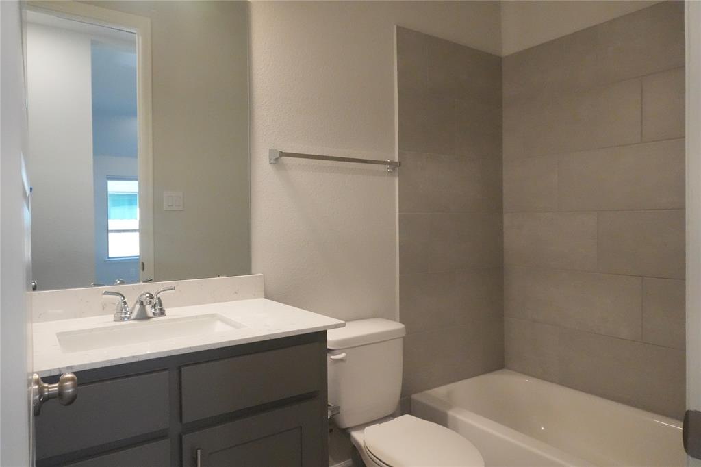 4115 Hudson Street Fate, TX 75087 - Photo 20 of 24 a bathroom with a sink toilet and vanity