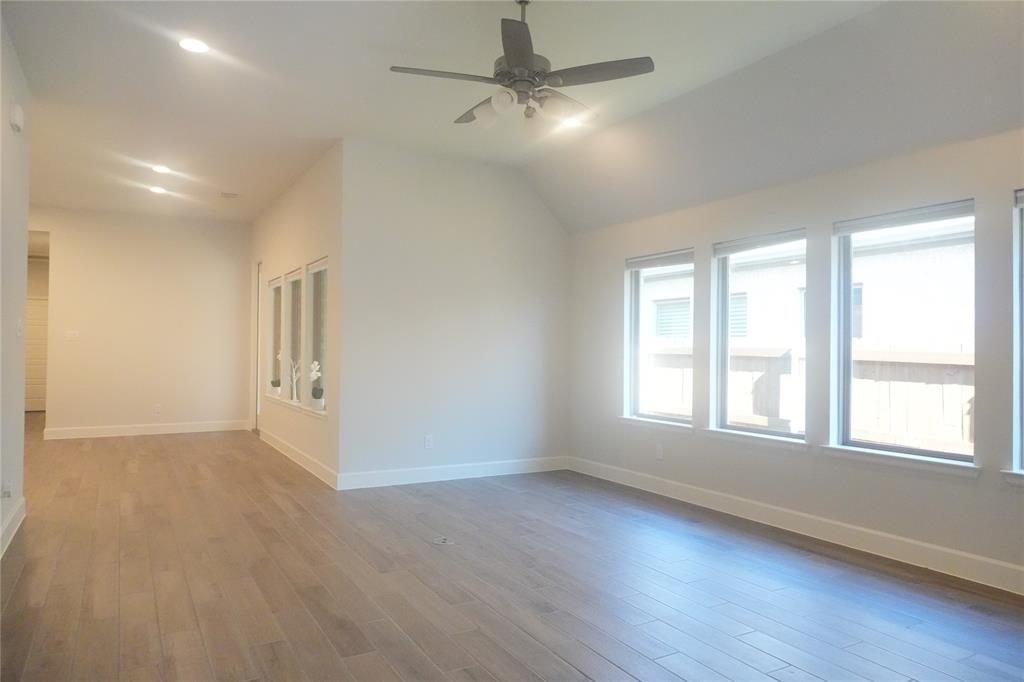 4115 Hudson Street Fate, TX 75087 - Photo 3 of 24 wooden floor in an empty room with a window