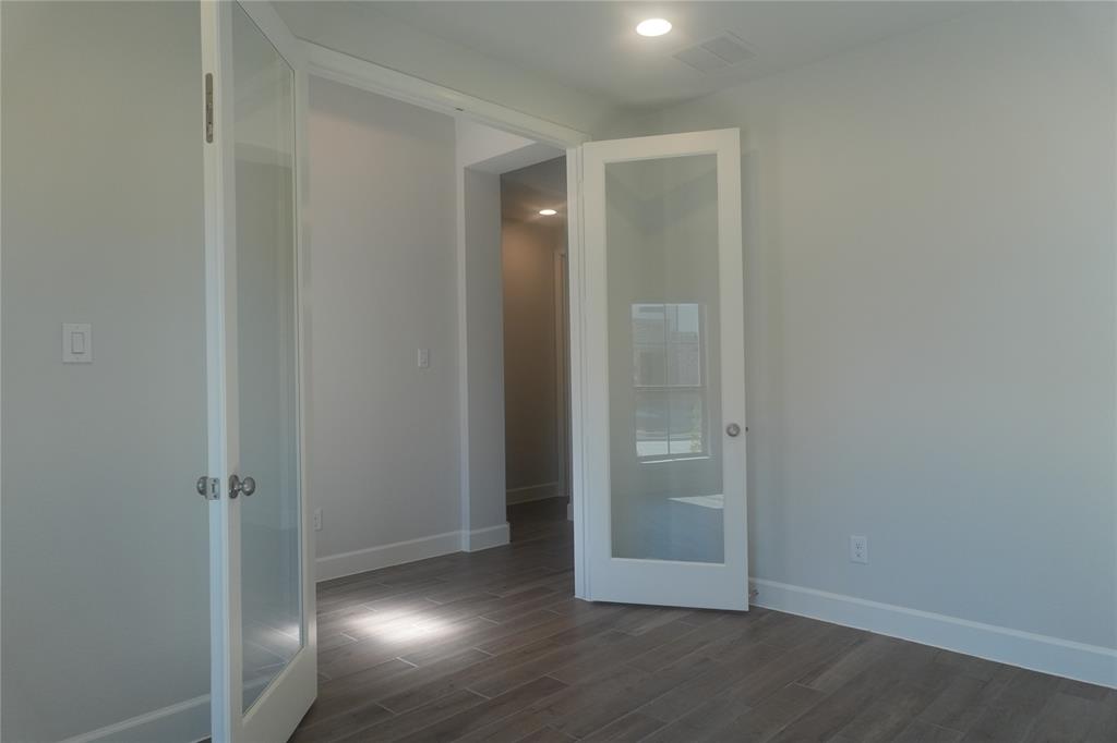 4115 Hudson Street Fate, TX 75087 - Photo 5 of 24 an empty room with wooden floor