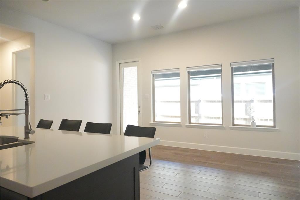 4115 Hudson Street Fate, TX 75087 - Photo 8 of 24 a bedroom with a bed and wooden floor