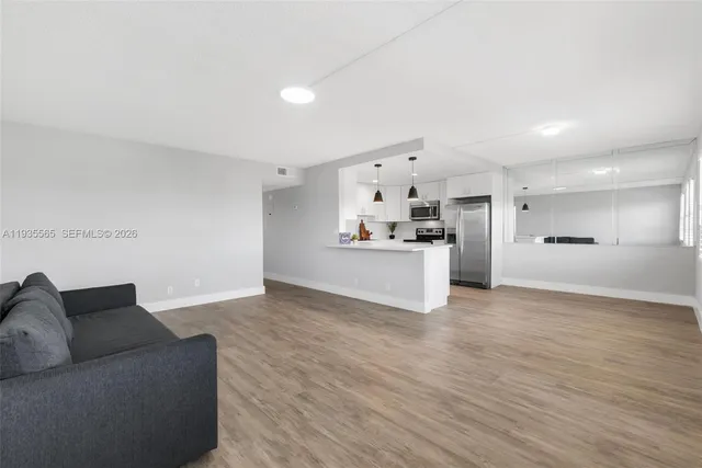 a view of kitchen with cabinets and wooden floor