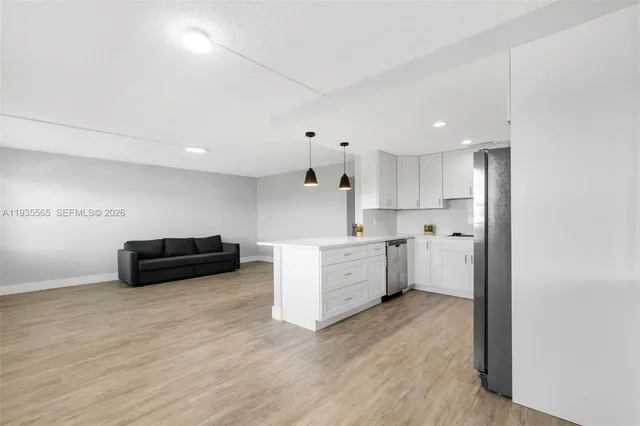 a kitchen with furniture a counter top space and stainless steel appliances