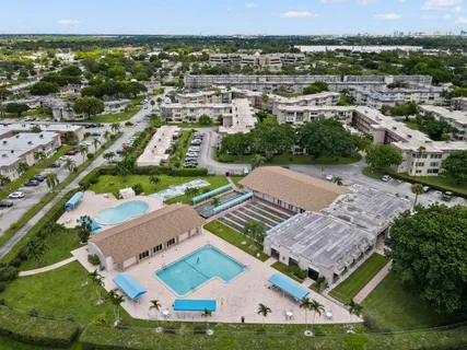 an aerial view of residential houses with outdoor space and street view