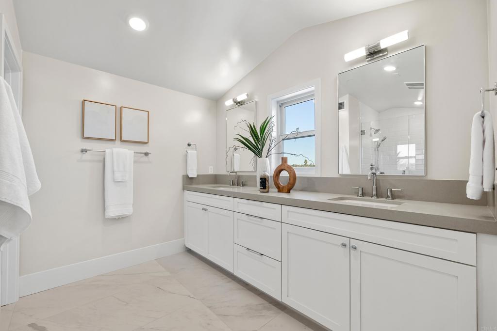 320 Chinquapin Avenue Carlsbad, CA 92008 - Photo 34 of 49 a bathroom with a double vanity sink and mirror