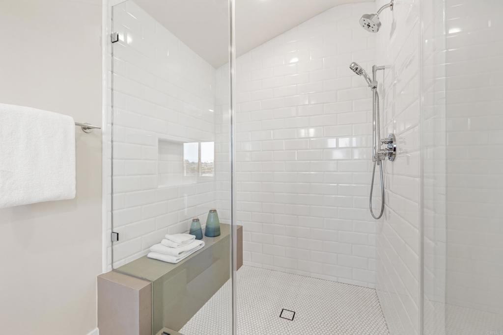320 Chinquapin Avenue Carlsbad, CA 92008 - Photo 36 of 49 a bathroom with a shower a mirror and a sink