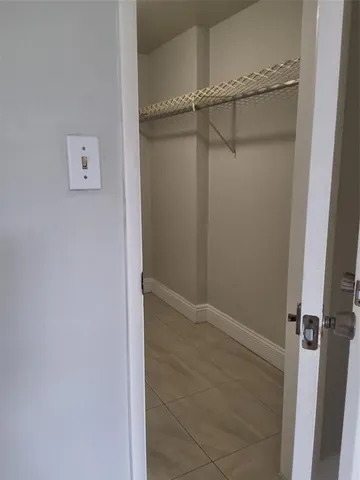 a view of an empty room and wooden floor