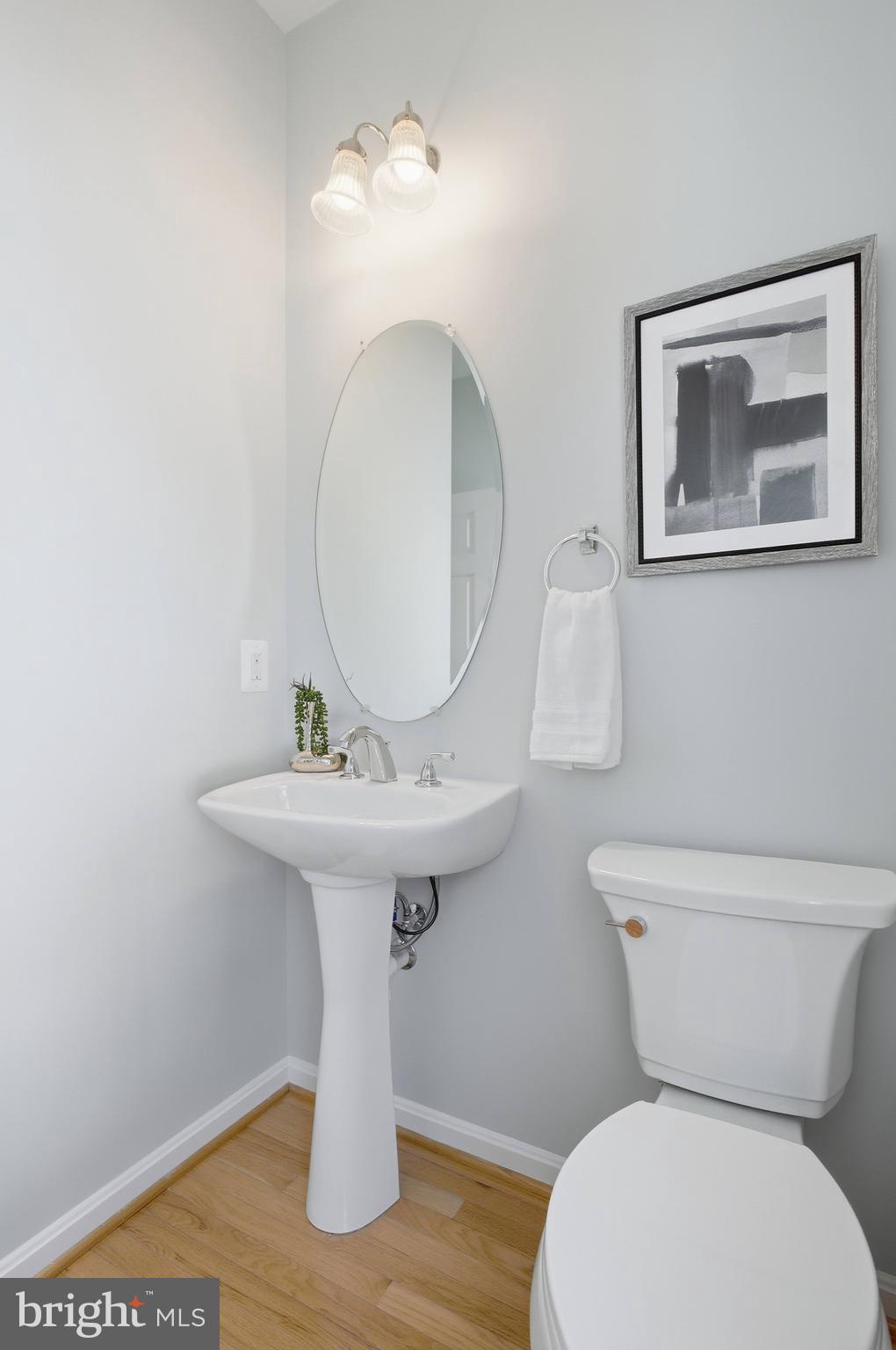 9013 Helmsley Drive Clinton, MD 20735 - Photo 15 of 68 a bathroom with a toilet sink and mirror