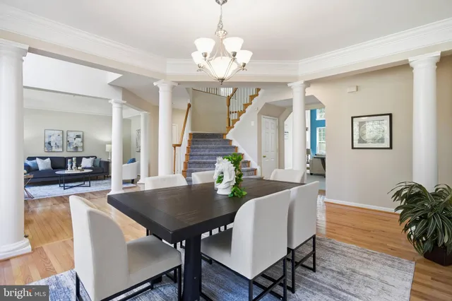 a open dining room with stainless steel appliances kitchen island granite countertop a stove a sink a dining table and chairs