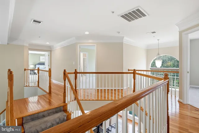 a spacious bedroom with a bed and a chandelier