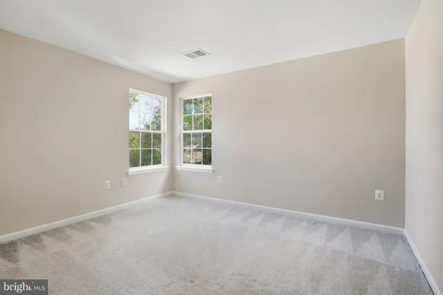 a spacious bathroom with a tub sink and mirror