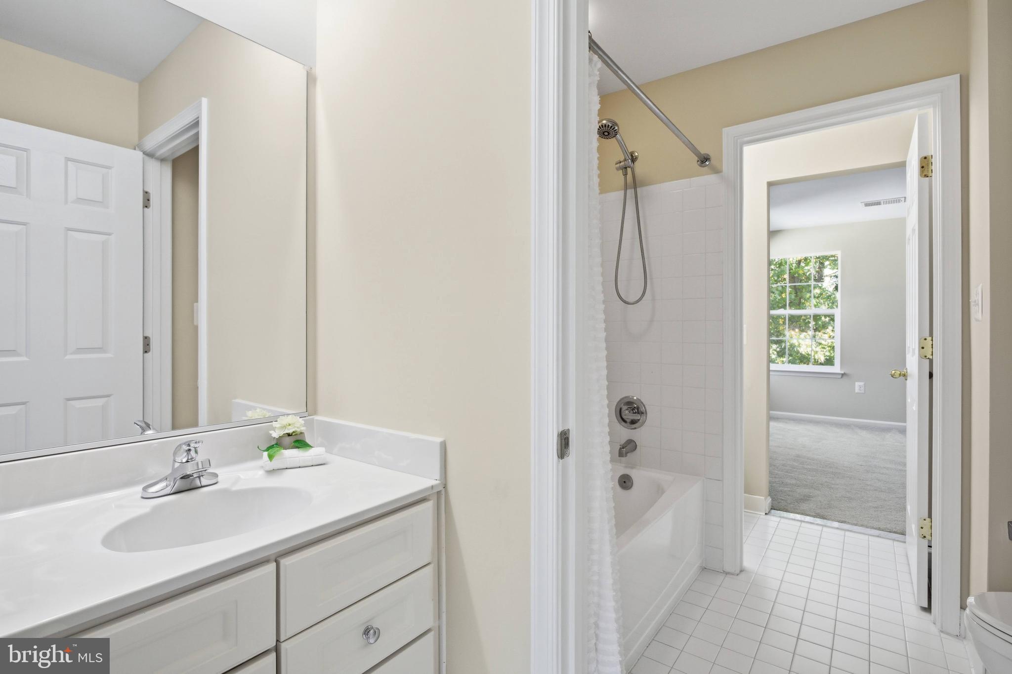 9013 Helmsley Drive Clinton, MD 20735 - Photo 35 of 68 a bathroom with a granite countertop sink tub and shower