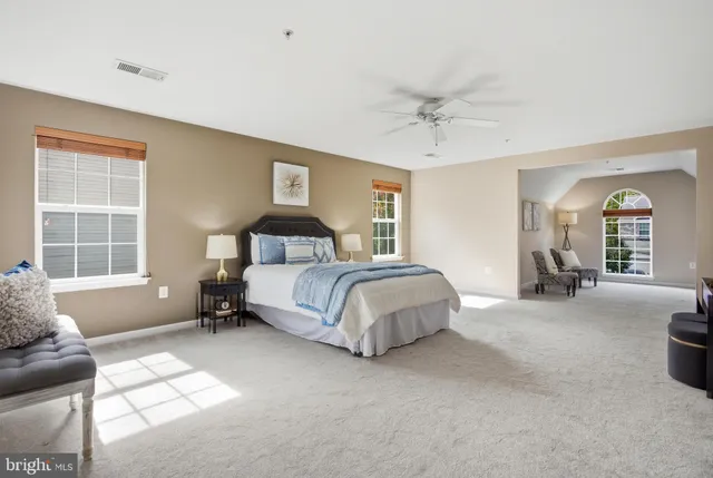 a view of an empty room with wooden floor and entryway