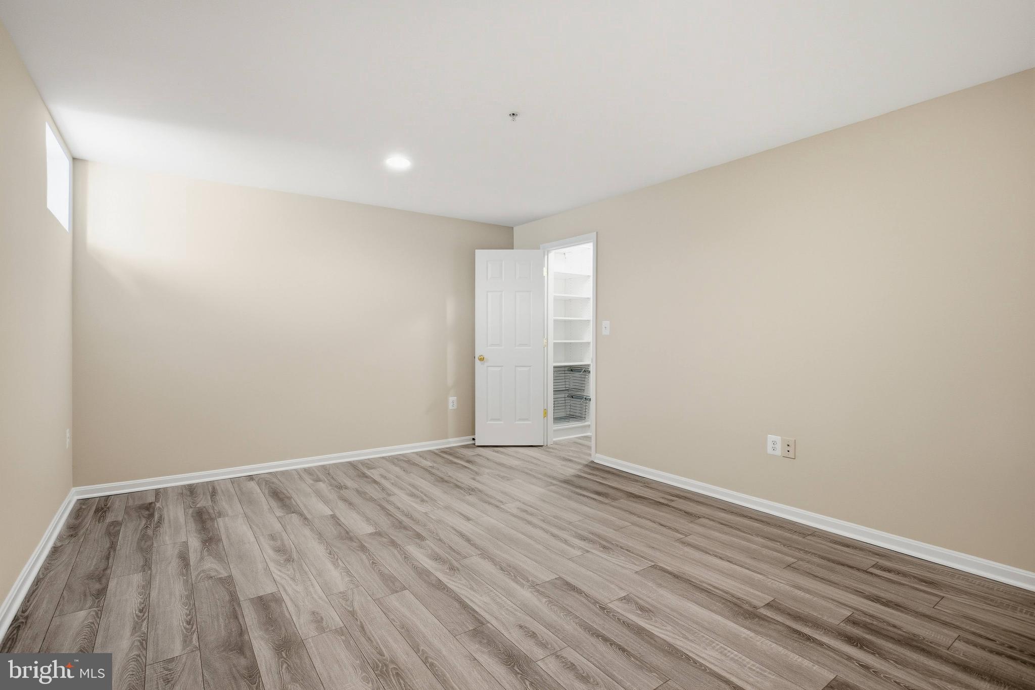 9013 Helmsley Drive Clinton, MD 20735 - Photo 51 of 68 a view of an empty room with wooden floor