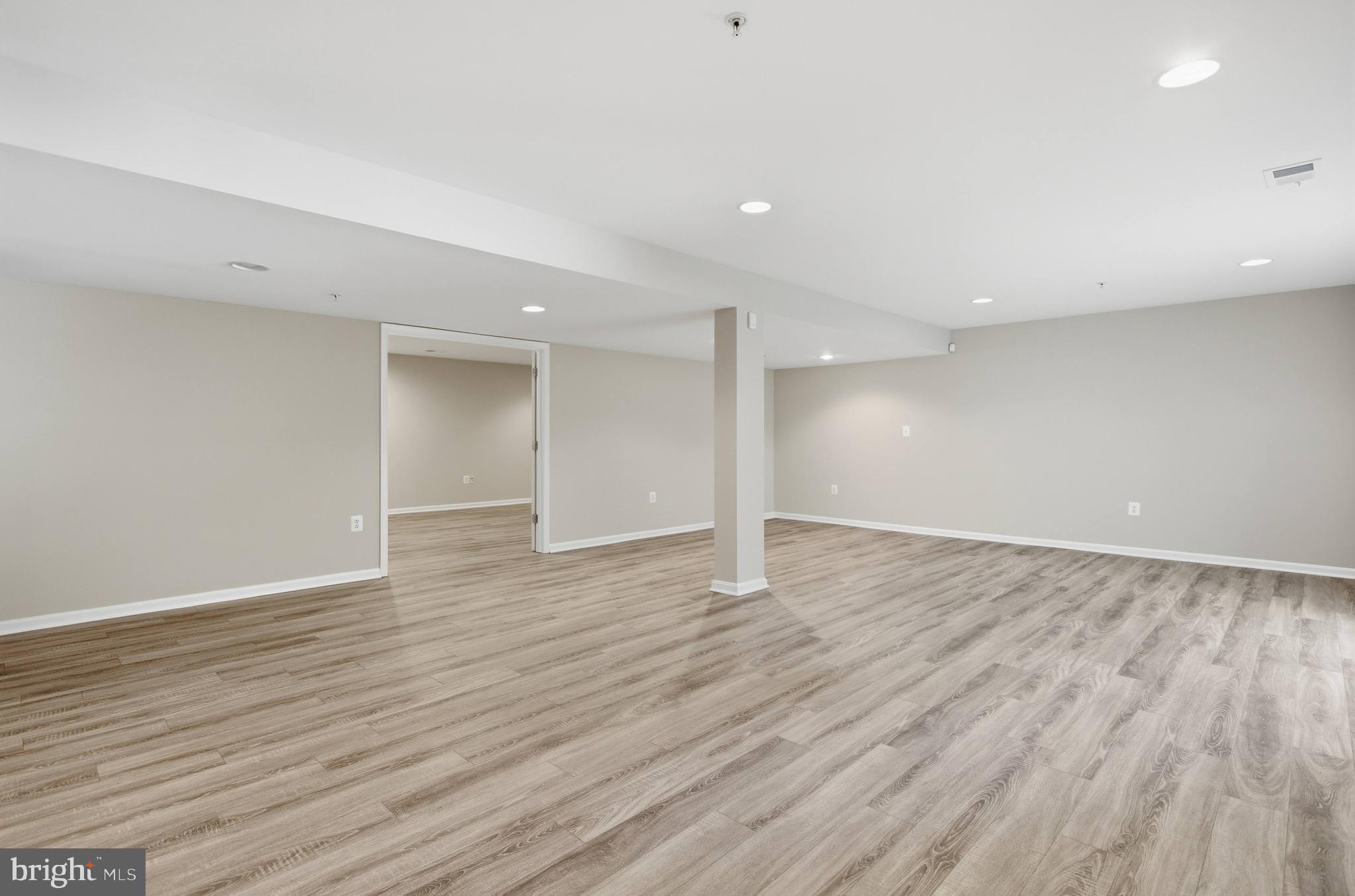 9013 Helmsley Drive Clinton, MD 20735 - Photo 55 of 68 a view of an empty room with wooden floor