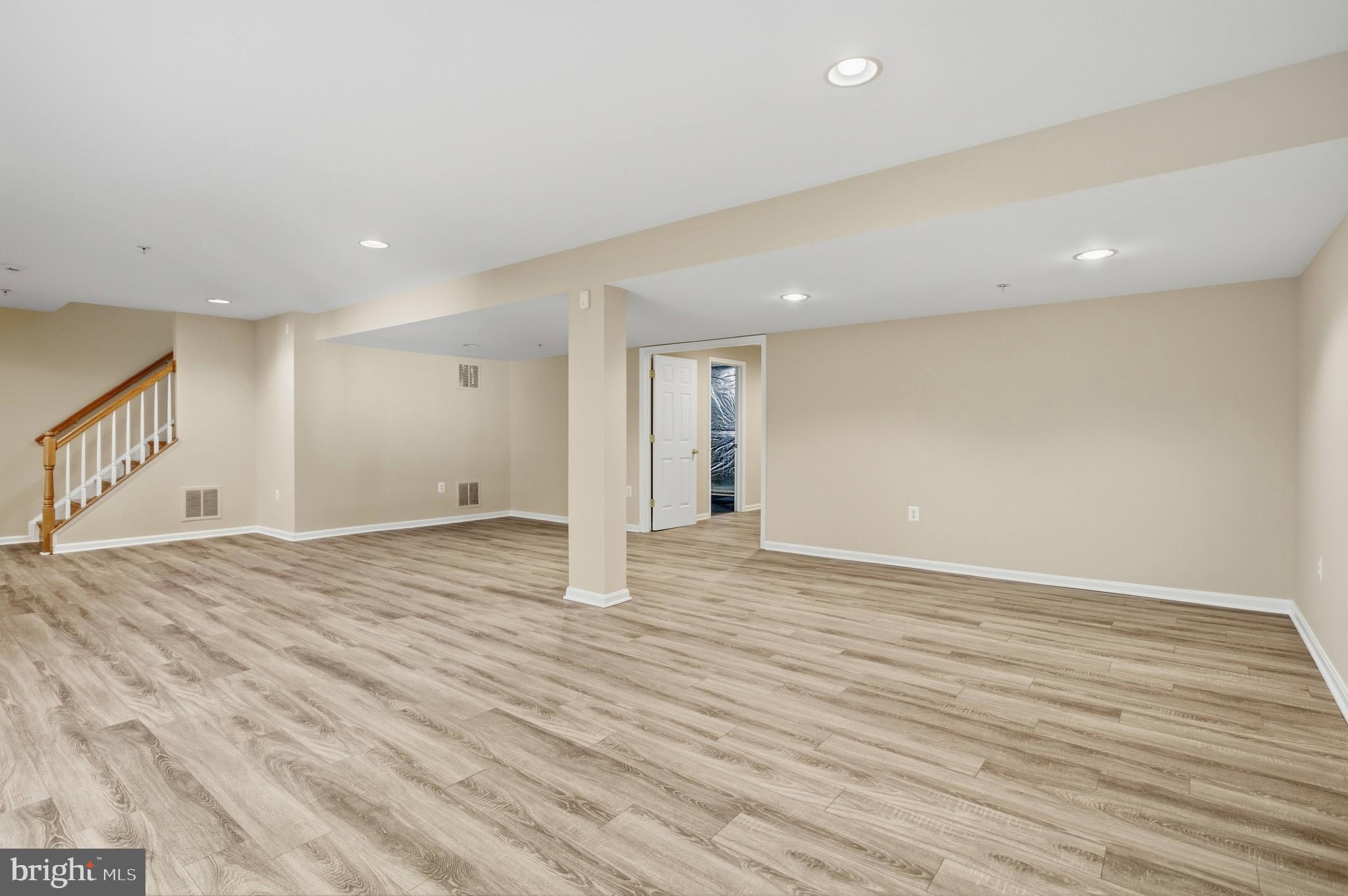 9013 Helmsley Drive Clinton, MD 20735 - Photo 56 of 68 a view of an empty room with wooden floor