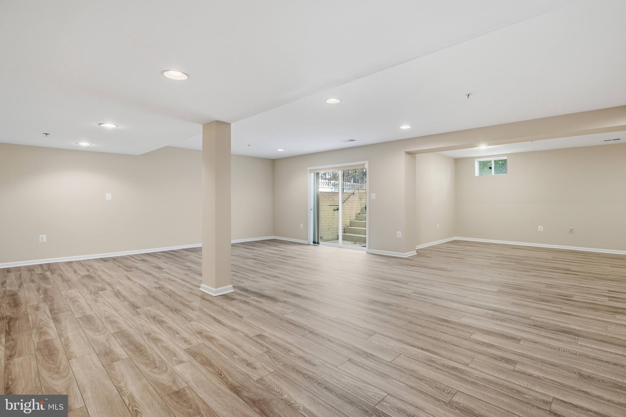 9013 Helmsley Drive Clinton, MD 20735 - Photo 58 of 68 an empty room with wooden floor and windows