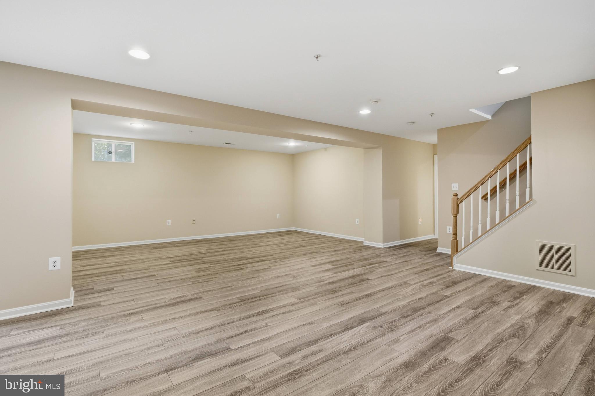 9013 Helmsley Drive Clinton, MD 20735 - Photo 59 of 68 a view of an empty room with wooden floor and entryway
