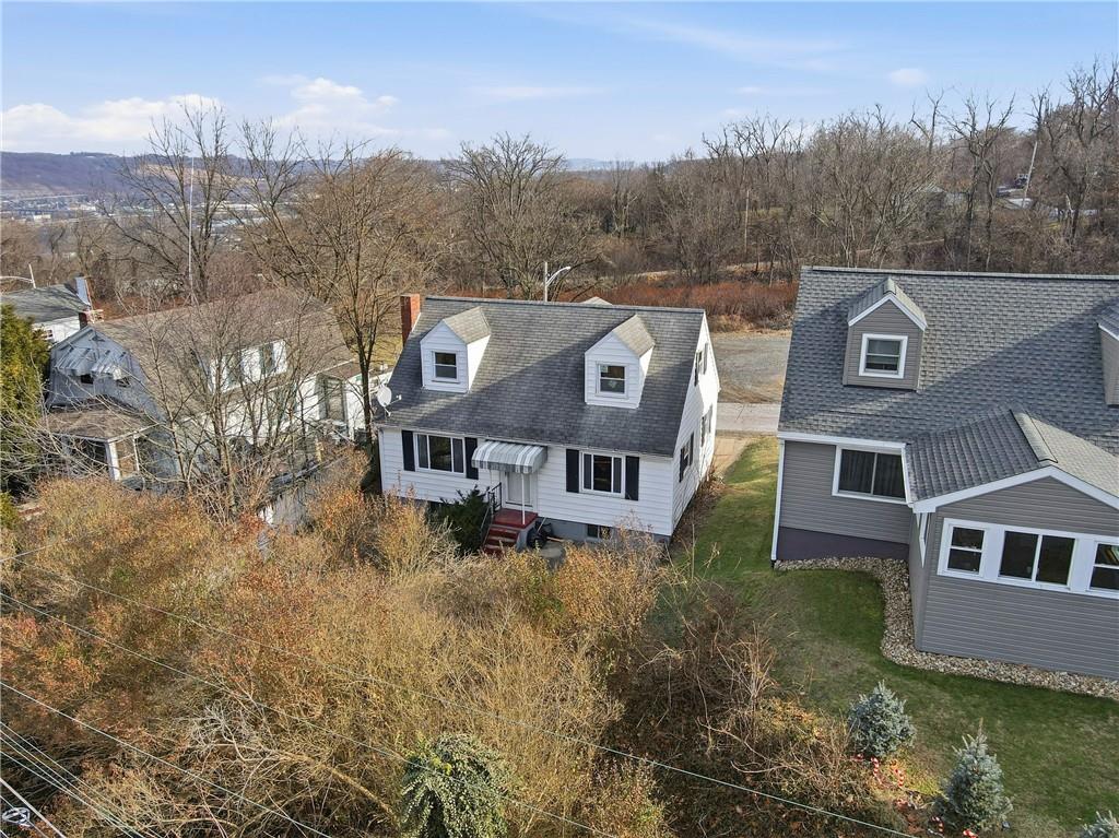 1865 Montour St Extension Coraopolis, PA 15108 - Photo 2 of 41 a aerial view of a house with a yard and mountains in the background
