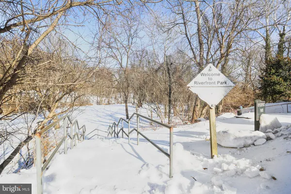 a view of a backyard with snow on the road