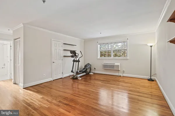 a view of a room with wooden floor and windows