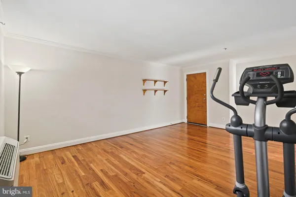 a view of empty room with wooden floor