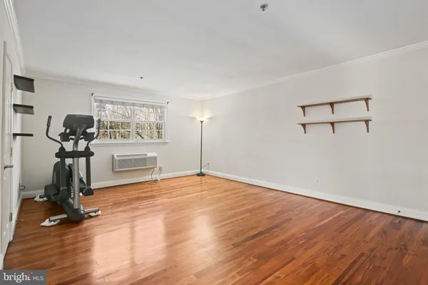 a view of a room with gym equipment and a table