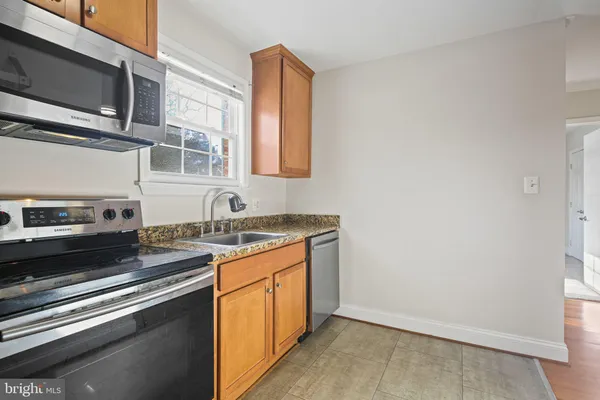 a kitchen with stainless steel appliances granite countertop a stove and a sink