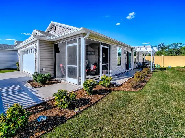 a view of a house with backyard and porch
