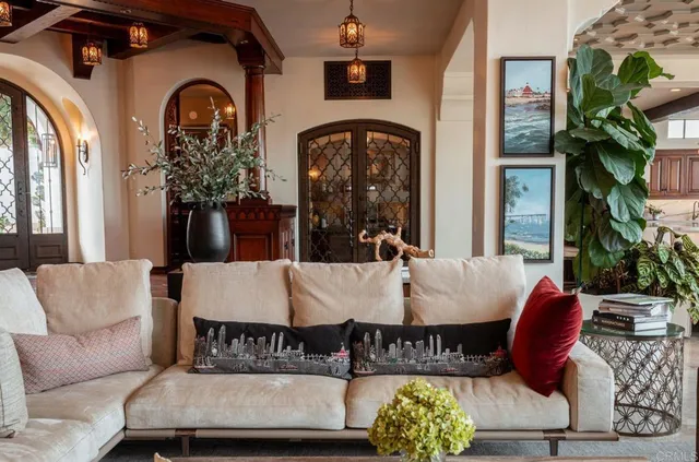 a view of living room filled with furniture and a potted plant