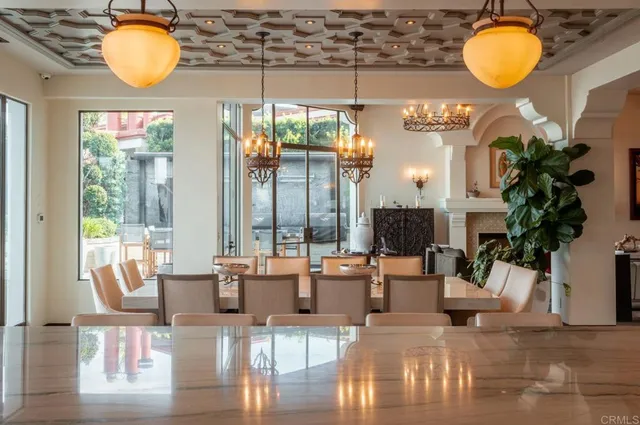 a living room with couches chair and a large window with wooden floor