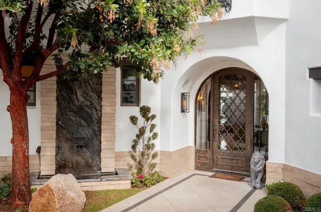 a front view of a house with a garden