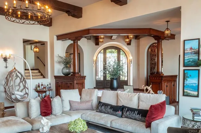 a living room with furniture and a mirror