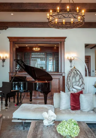 a living room with furniture a chandelier and a fireplace
