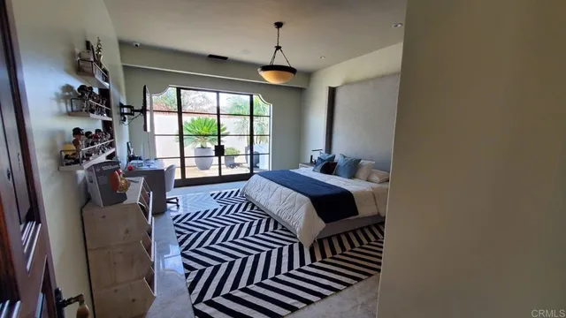 a bedroom with furniture and a window